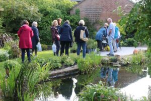 Garden with pond and people visiting